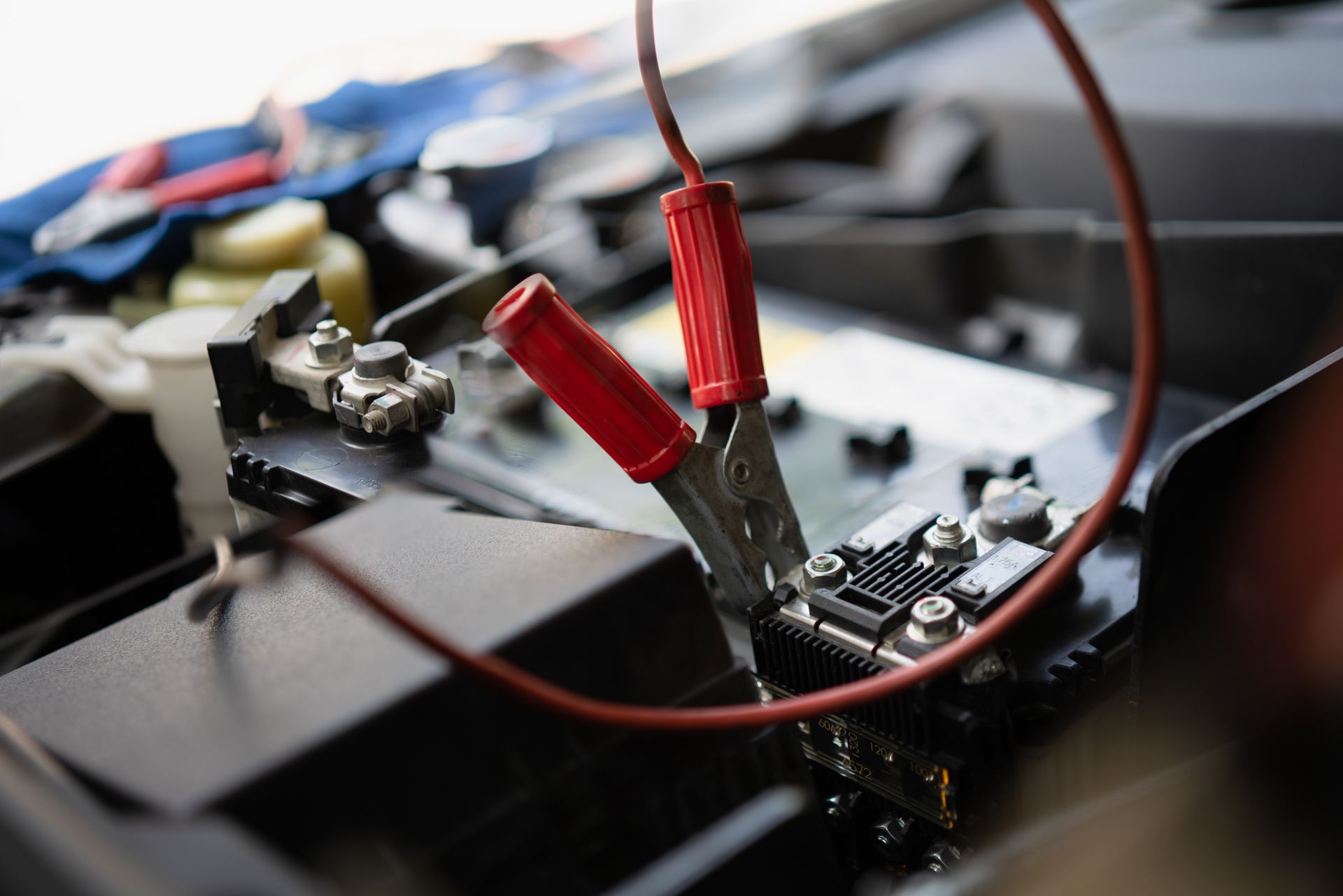 A Close Up of a Car Battery Being Charged With Jumper Cables