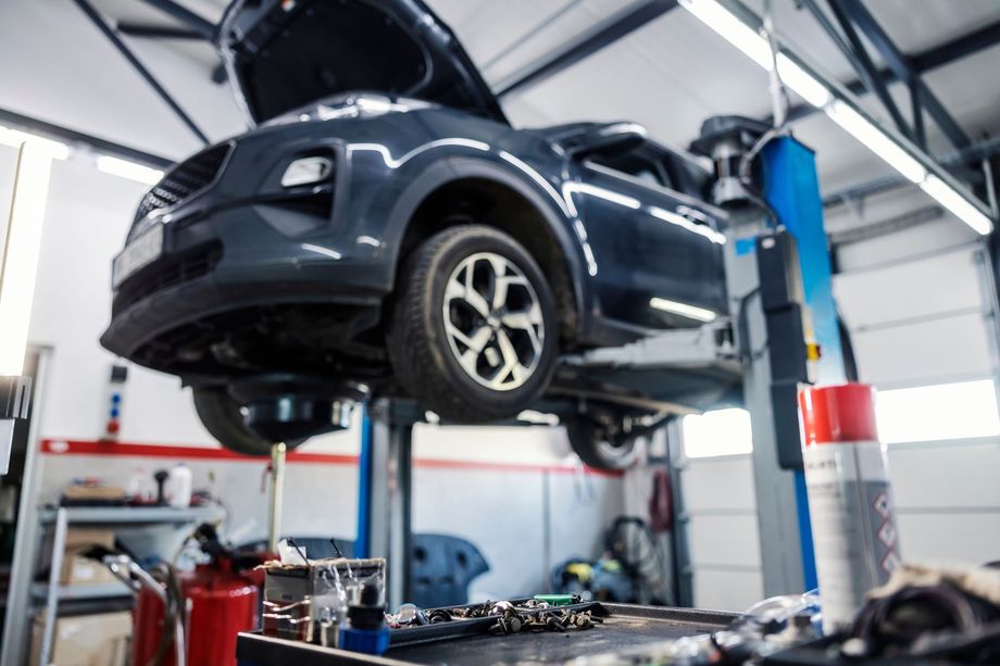 A Car is Sitting on a Lift in a Garage