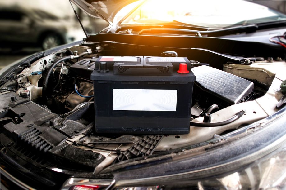 A Car With the Hood Open and a Battery in the Engine Compartment
