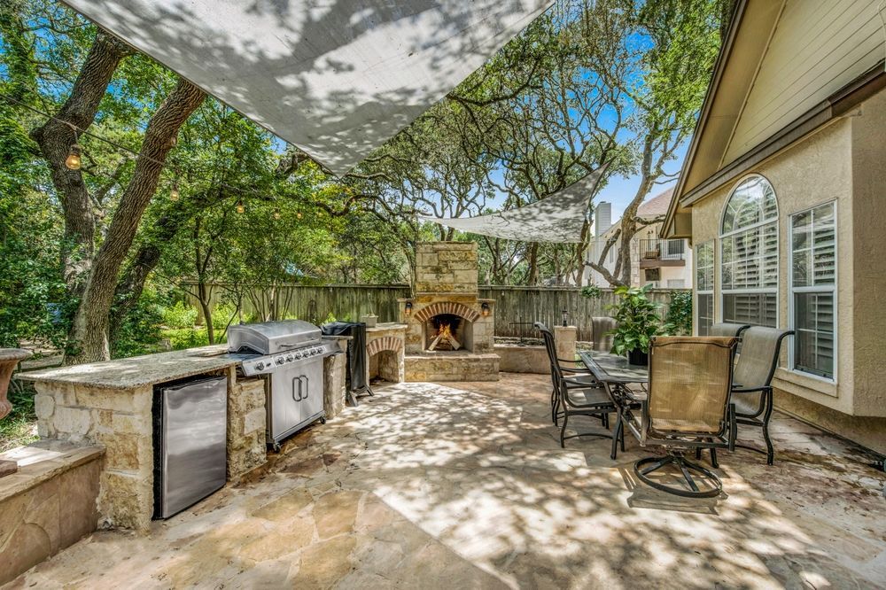 There is a grill and a fireplace in the backyard.