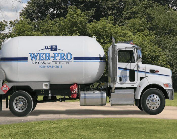 White Web Pro water truck parked on a road beside greenery, with blue branding on the tank.