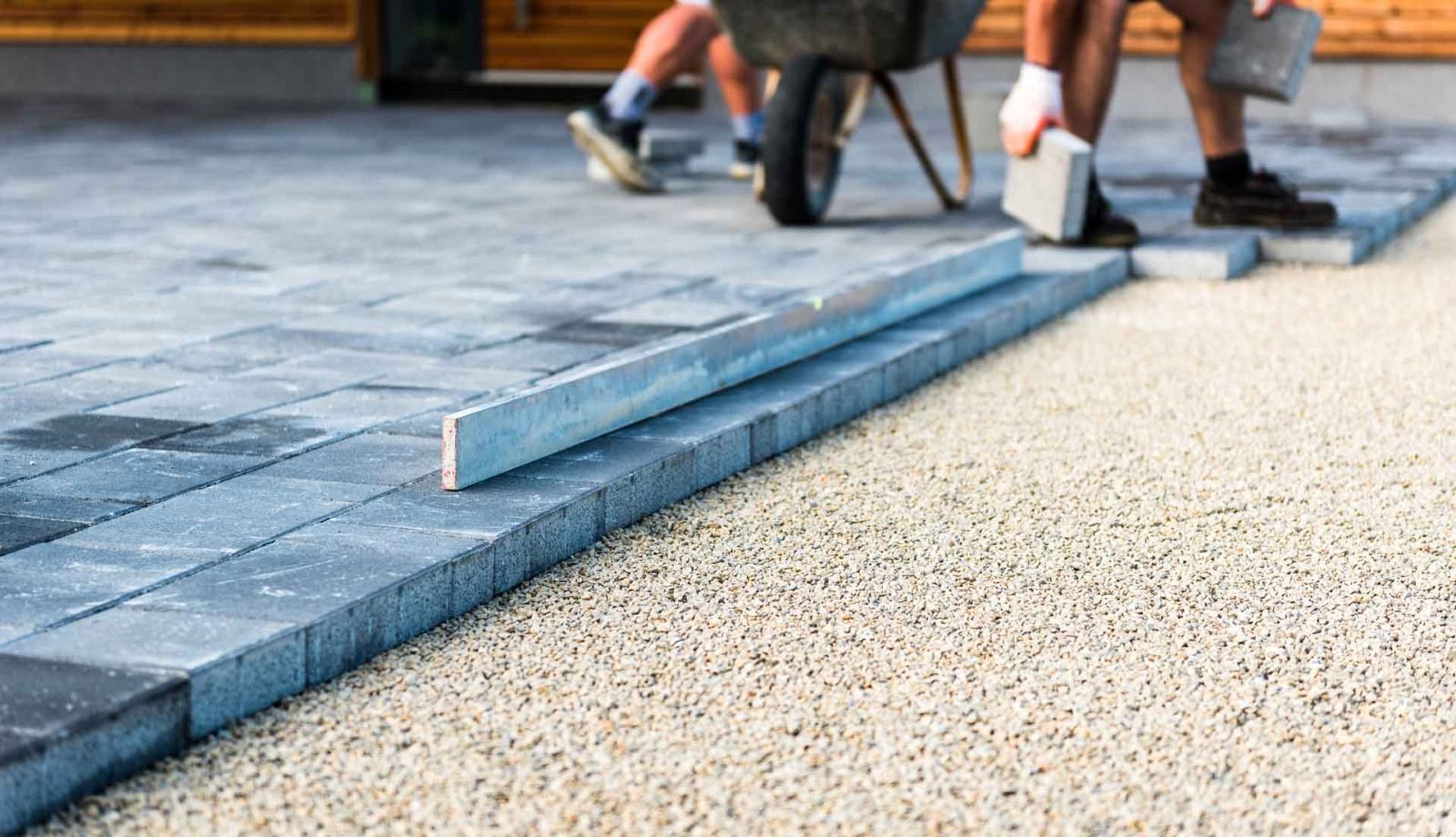 Paver patio being installed over a gravel base
