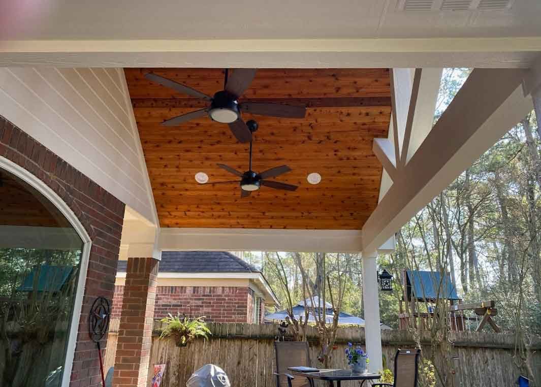 Modern cedar-covered ceiling with blade fans