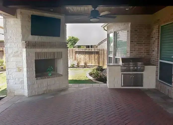 Covered patio with fireplace and kitchen