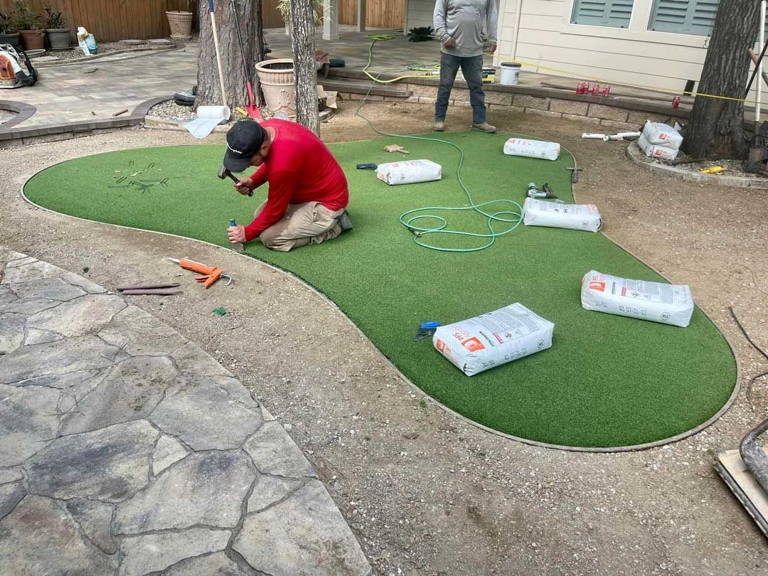 Men at work artificial turf installation