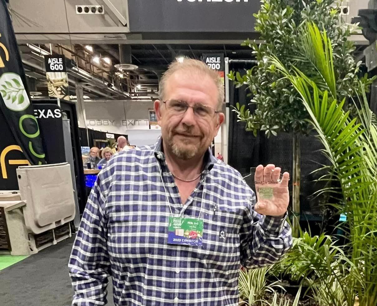 CW McKay holding the 2023 Best Booth Award!