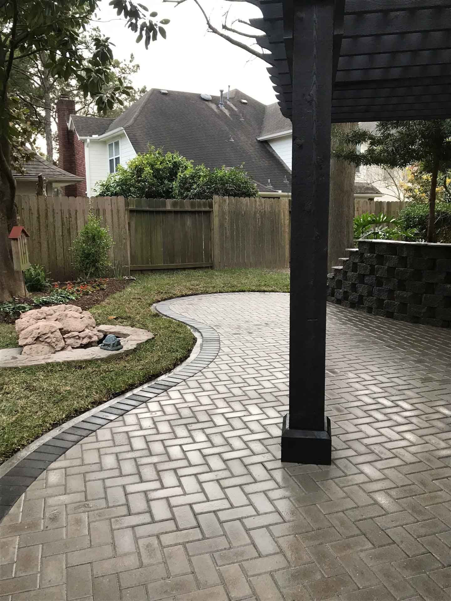 Backyard paver patio diagonal bricks covered with pergola