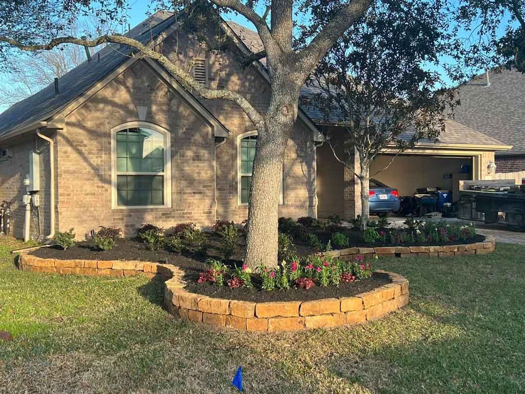 Landscaping circular stone design with plants and a tree