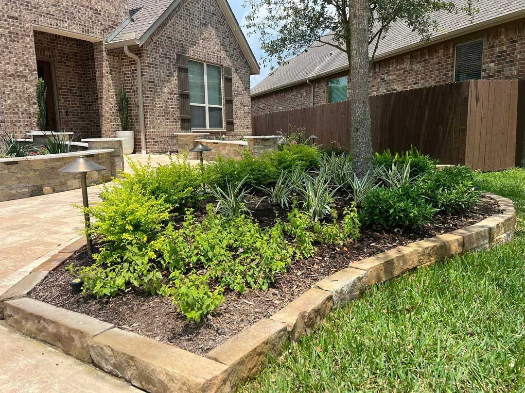 Landscaping of square stones with plants and a tree
