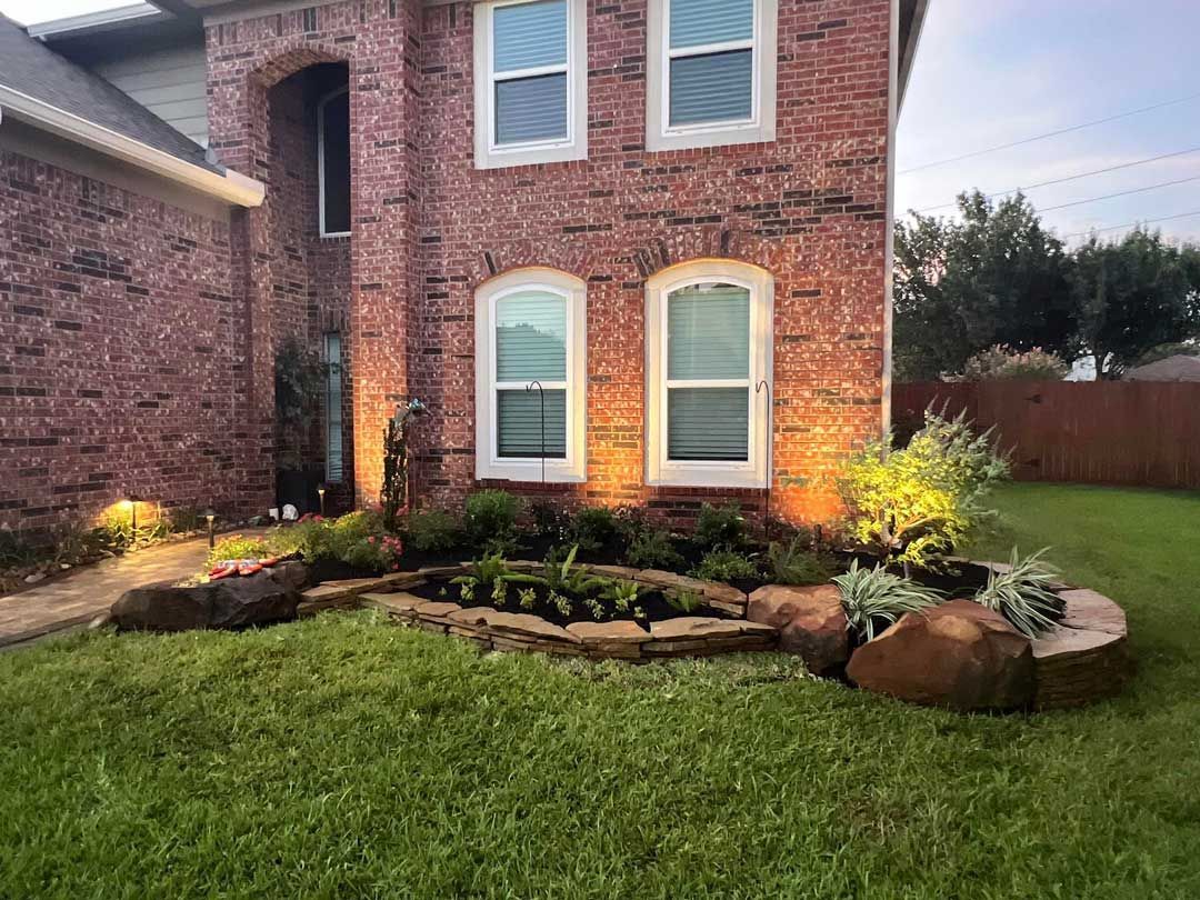 Small stone landscaping bed with plants