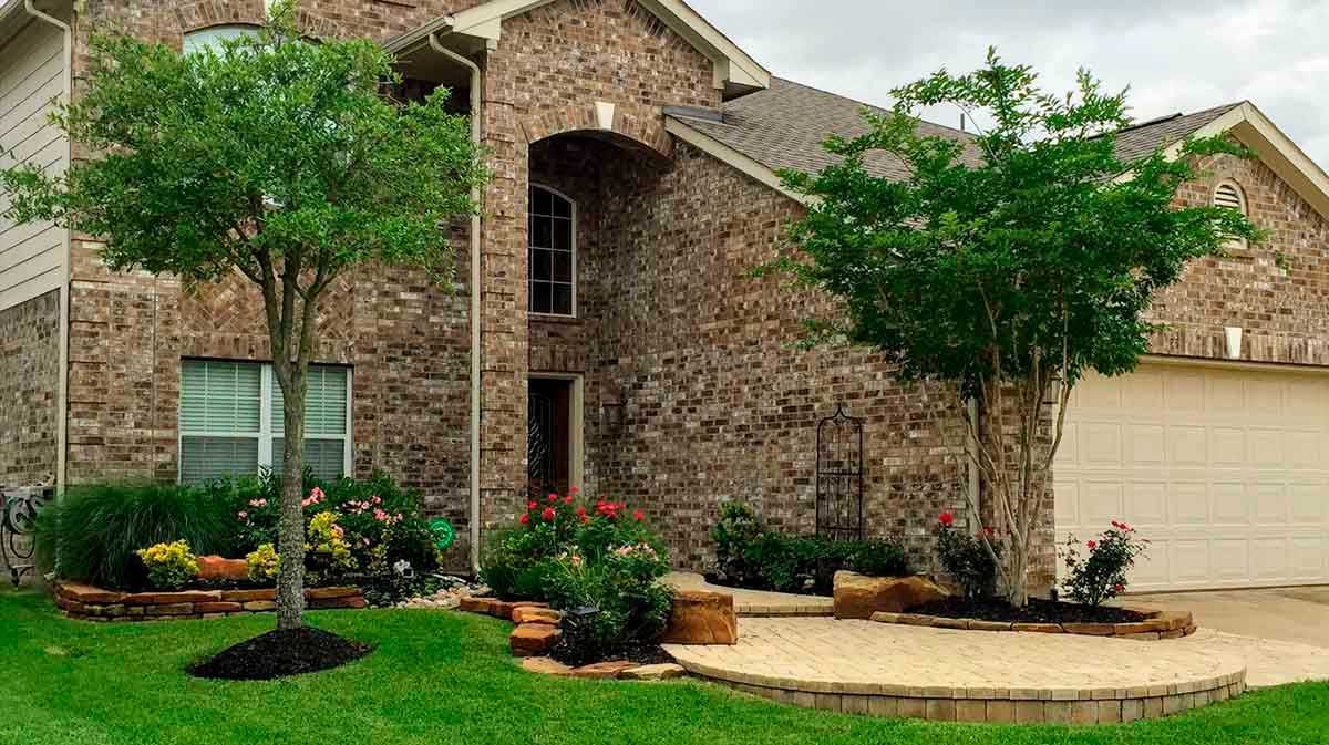 Elegant landscaping design with flowers and yellow brick pathway