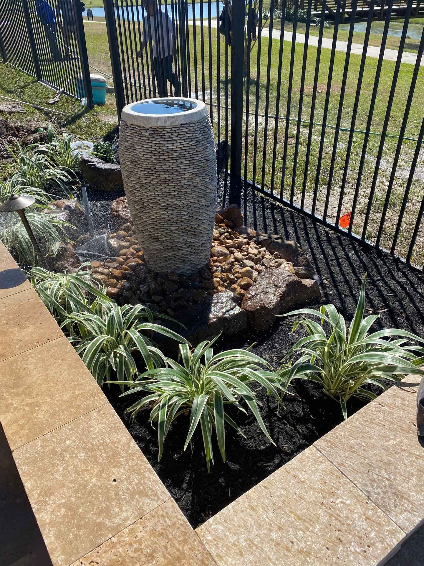Landscape bed with a fountain and stone
