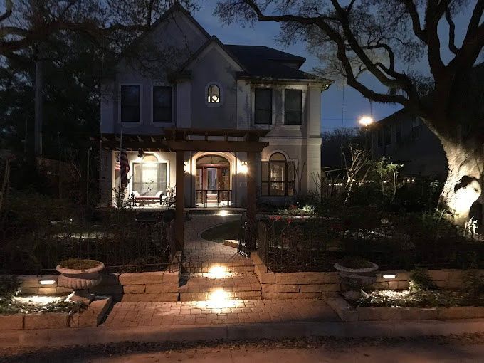 Illuminated stone pathway at the entrance of the house
