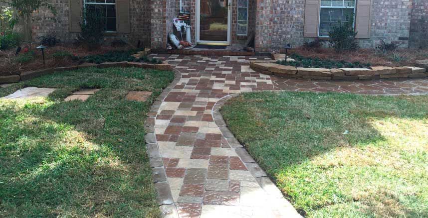 A pathway made of bright pavers in different colors for the house entrance