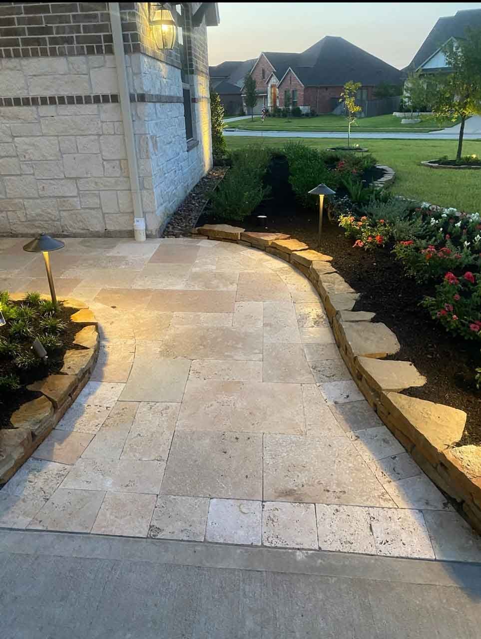 Walking path in pavers with landscaping with flowers and plants