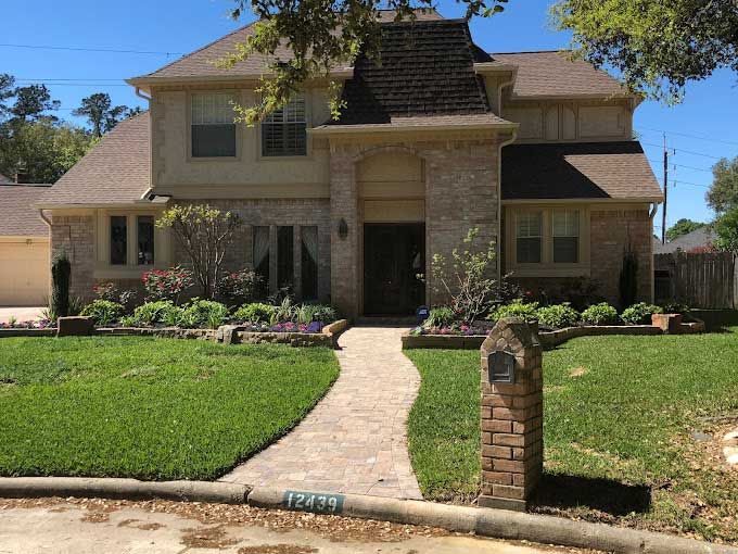 Pavers pathway surrounded by landscaping beds for appeal