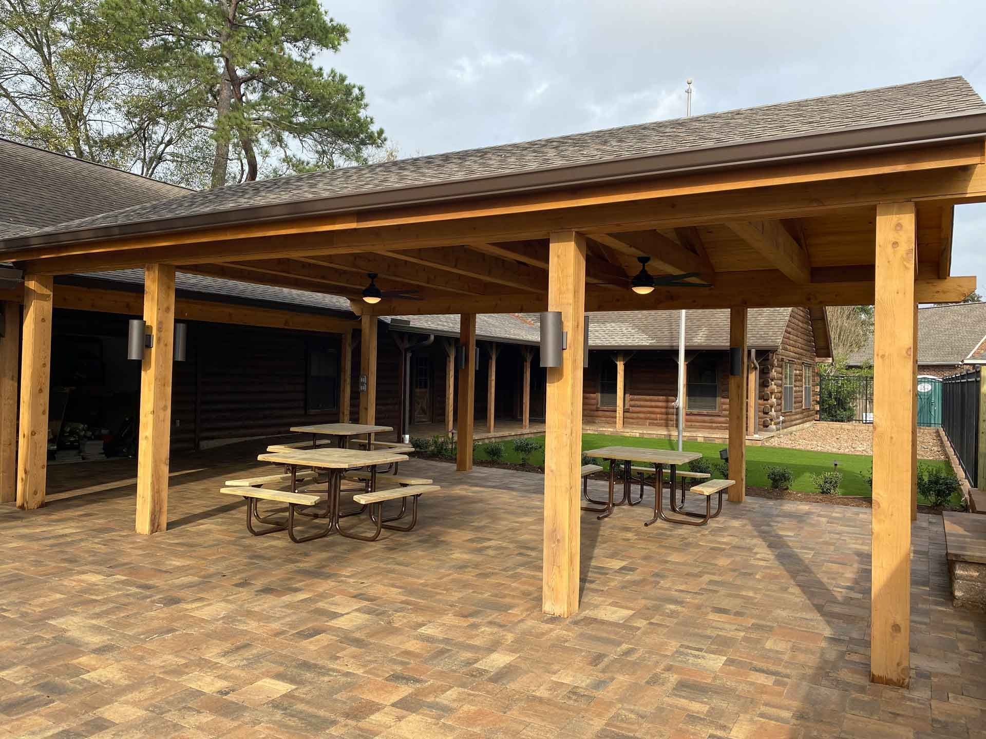 Commercial custom covered patio with pavers and landscaping
