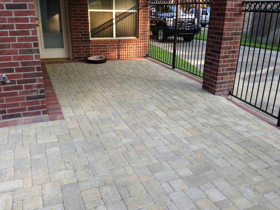 Gray brick courtyard enclosed with fences
