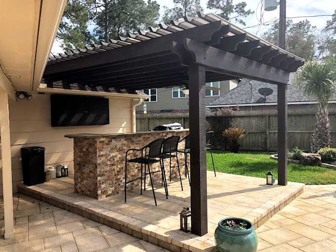 Dark cedar pergola with outdoor kitchen