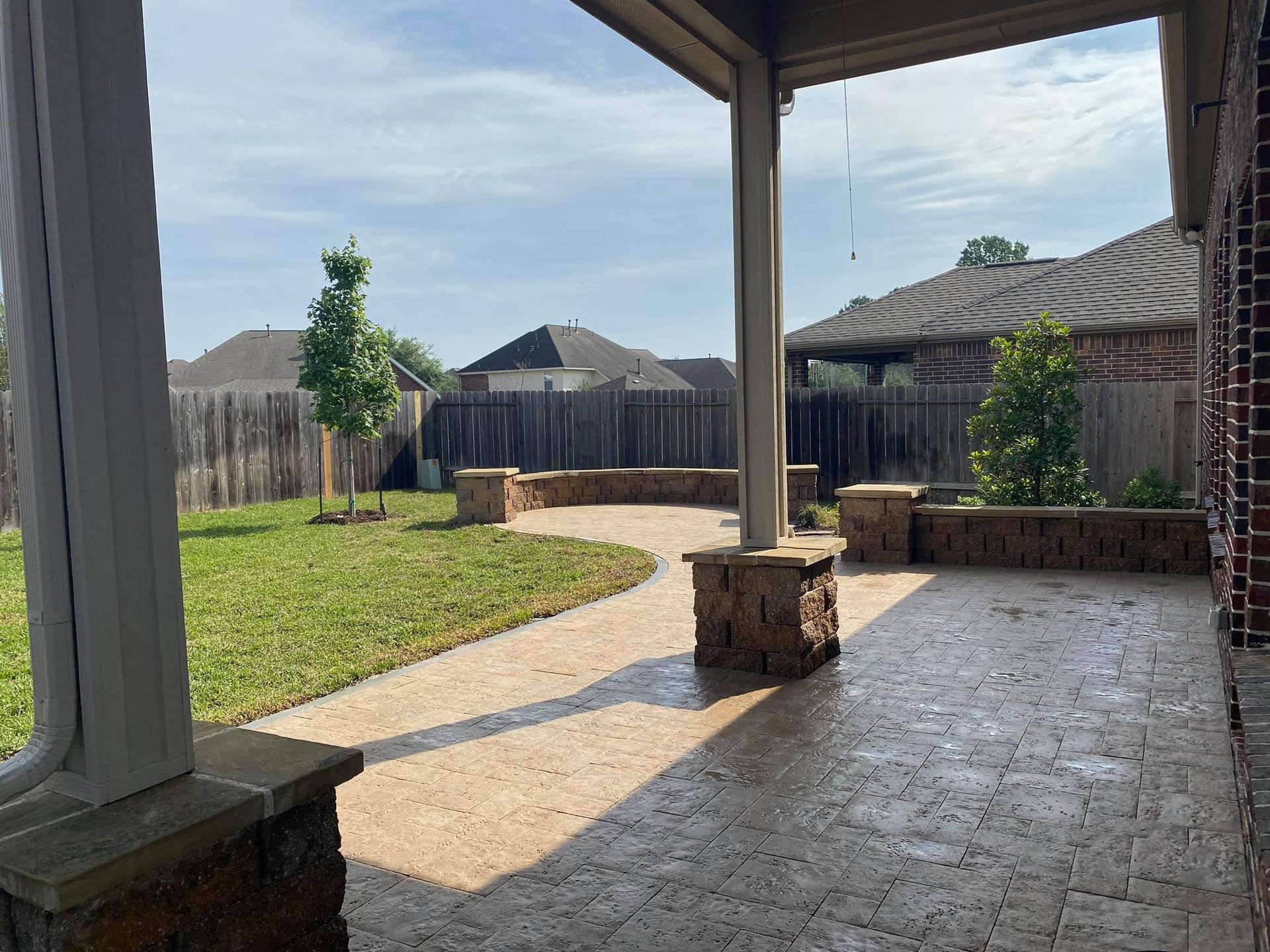 Outdoor backyard paver patio with the fire pit area