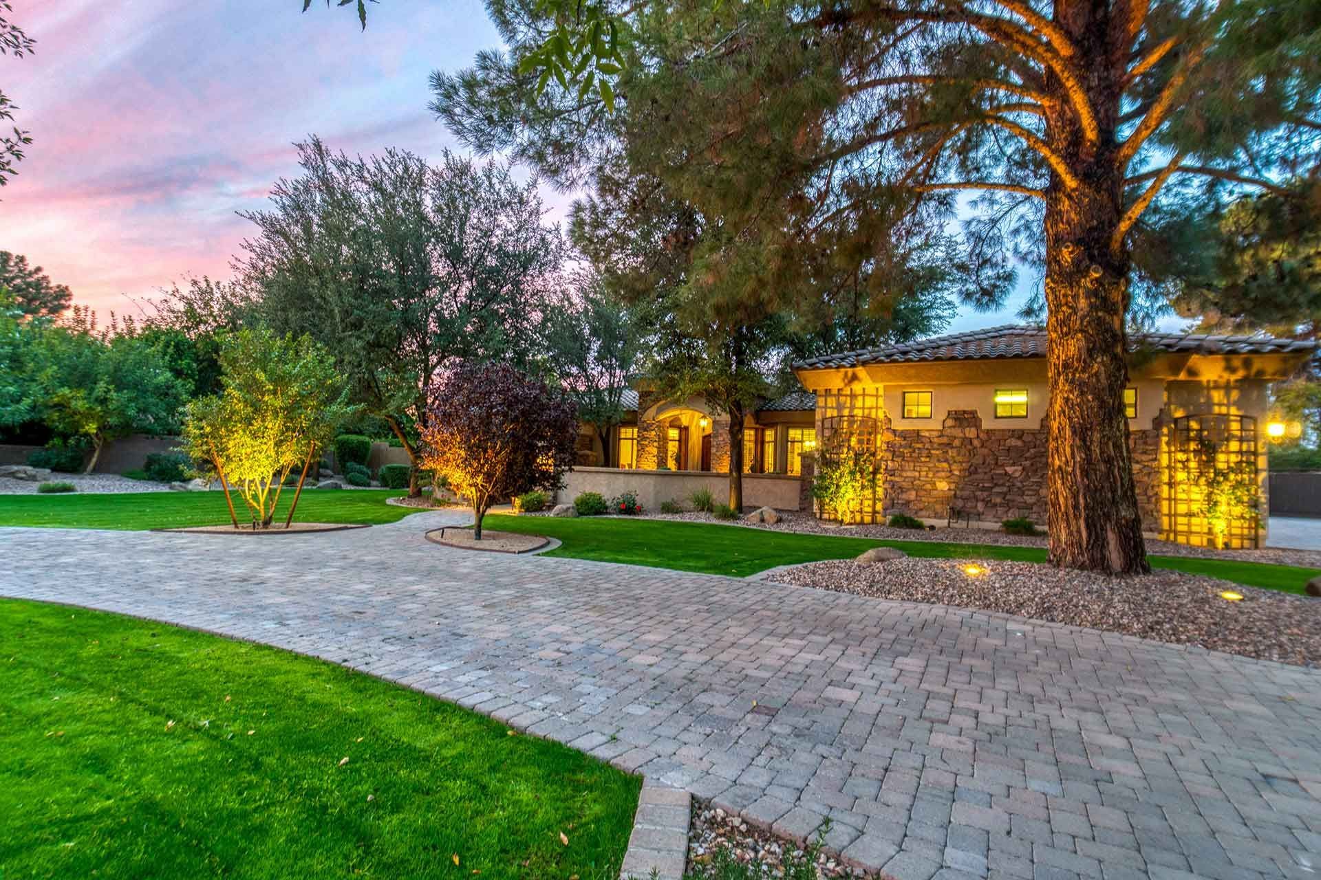 Pavers driveway with outdoor lighting and landscaping