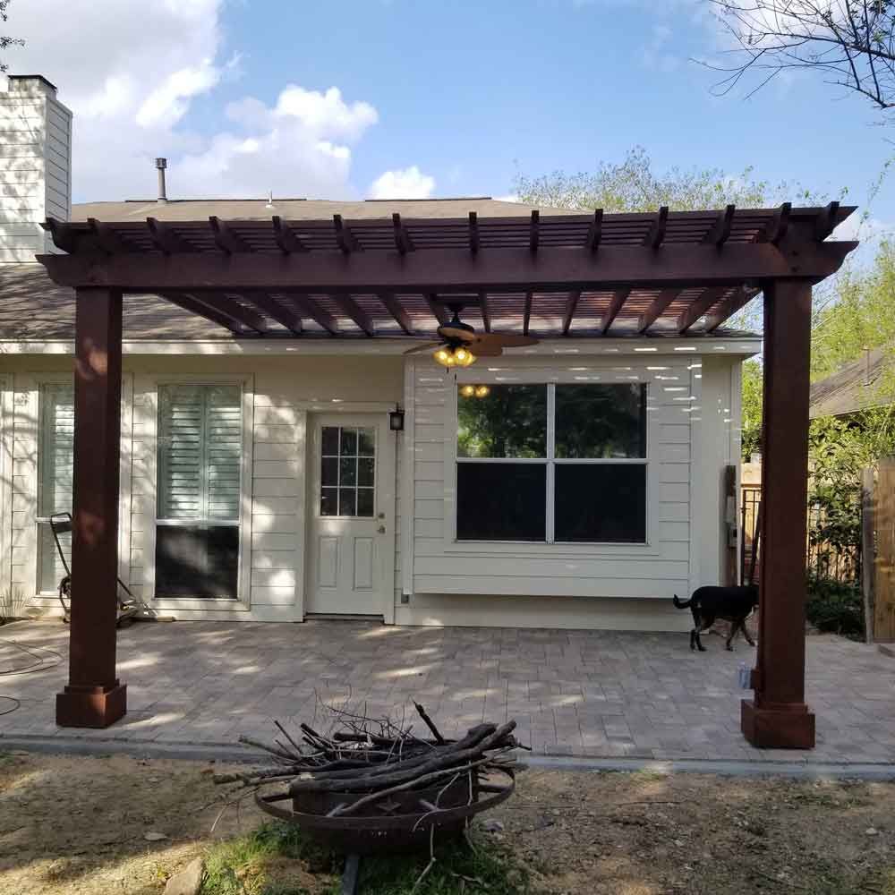 Backyard custom cedar pergola in a pavers patio