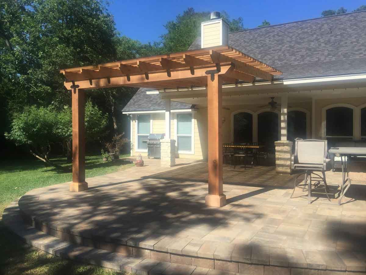 Beautiful paver patio with timber pergola in backyard
