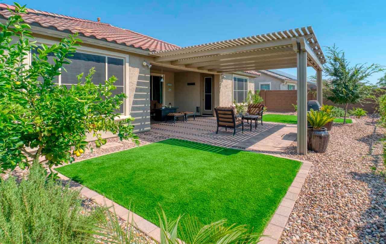 Artificial turf backyard patio with pergola