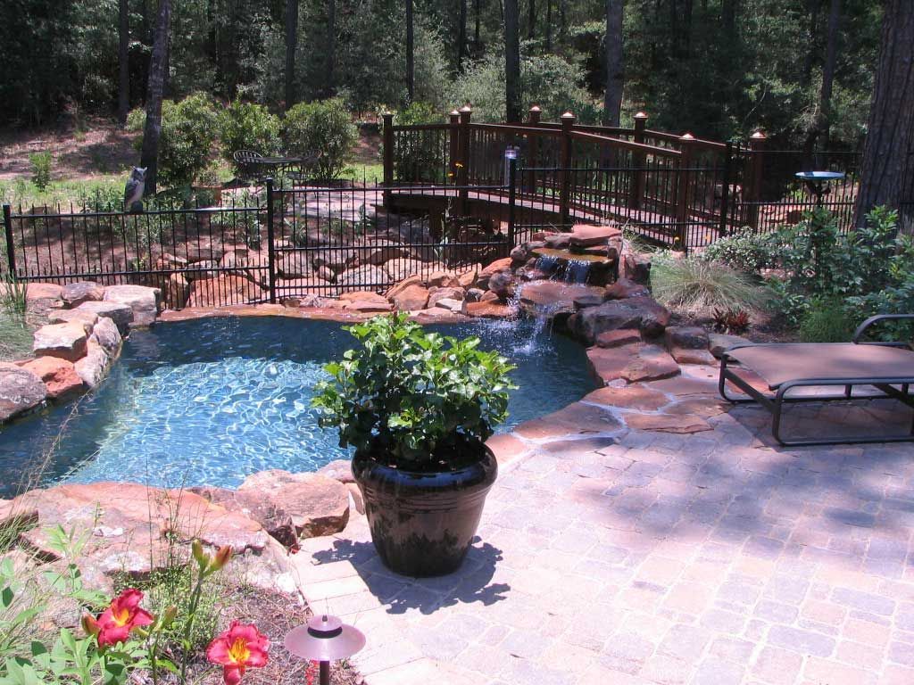 A small pond with a stone waterfall fountain
