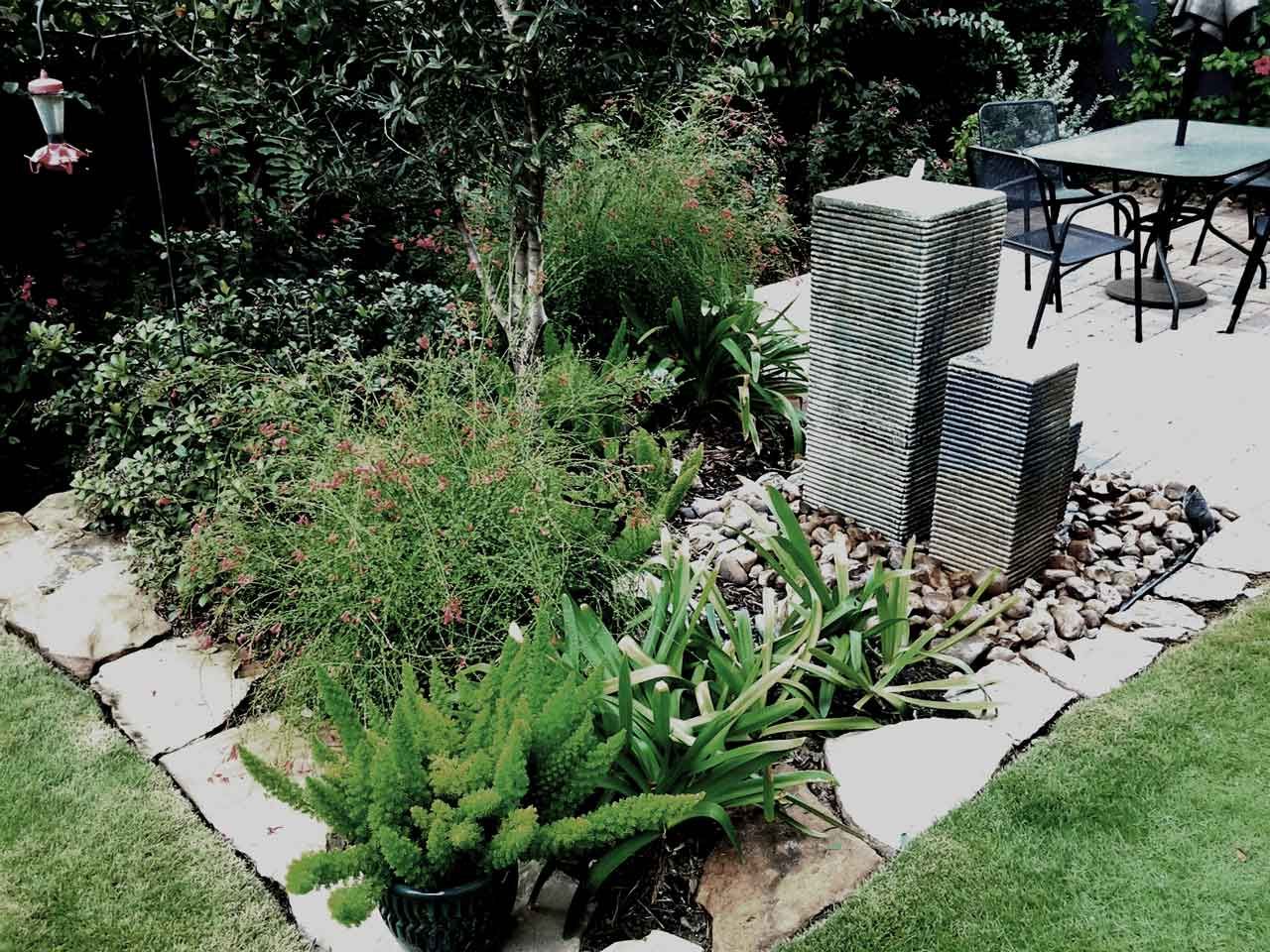 Nice landscaping with banded square tower fountain