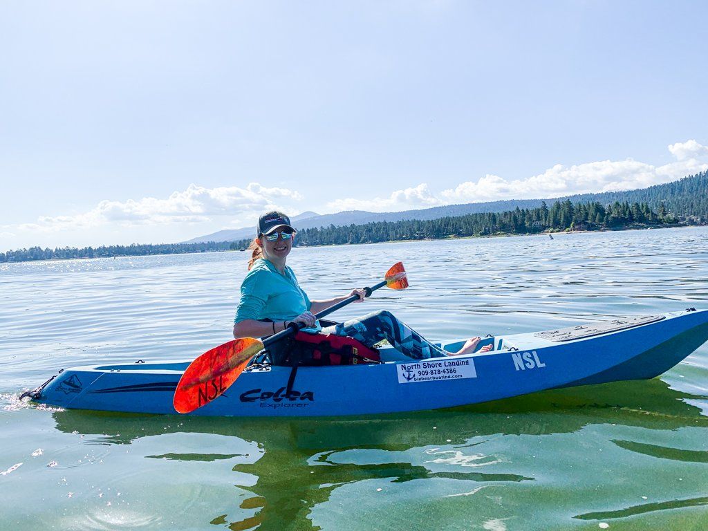 three people in a pontoon on the water
