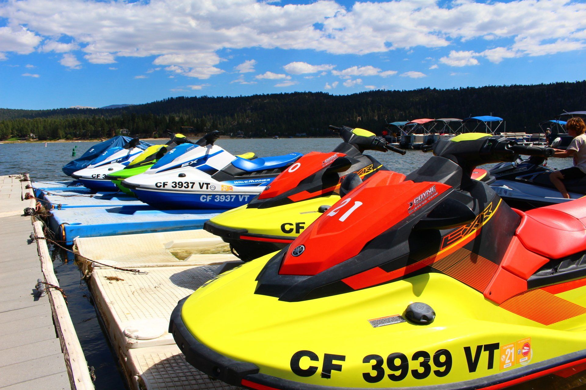 3 colorful jet skis docked in big bear lake