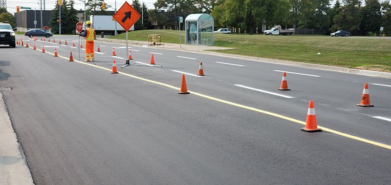 freshly painted lines on a road with cones 
