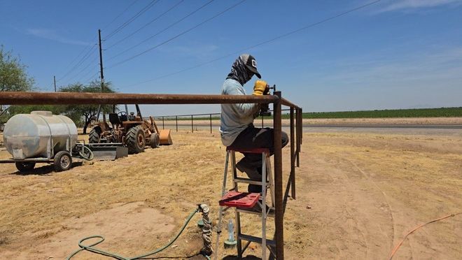 CS Fence Services working on an agricultural Pipe fence in Maricopa