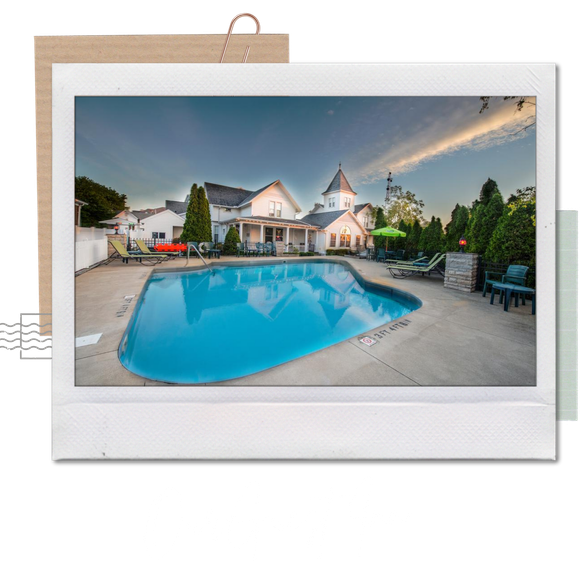 A picture of a large swimming pool in front of a house
