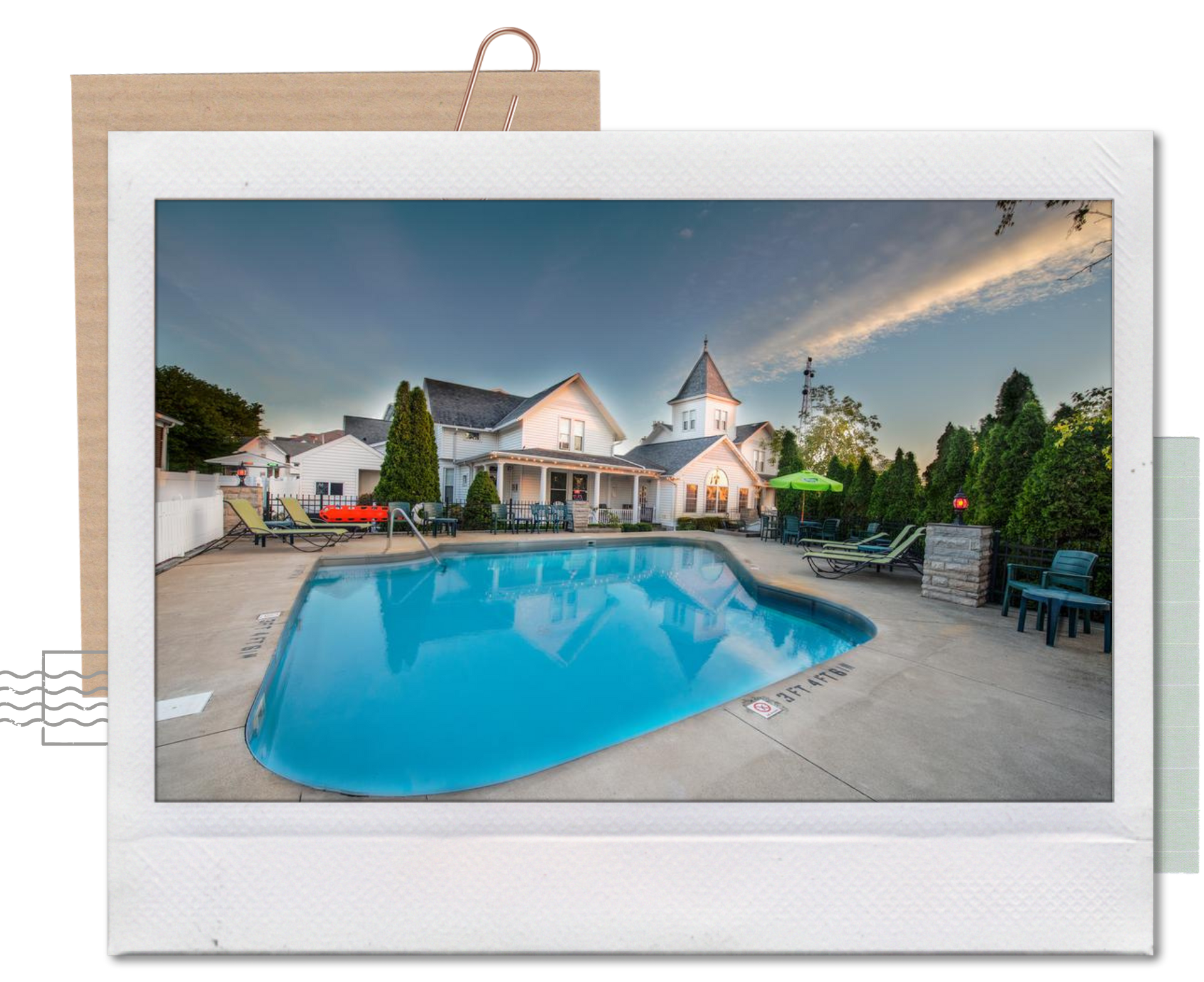 A picture of a large swimming pool in front of a house.