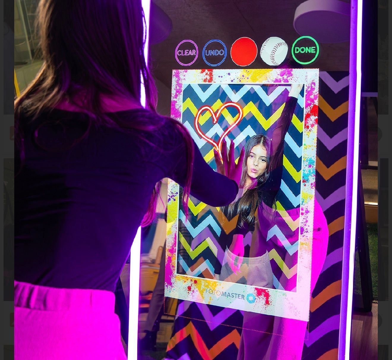 woman drawing on touchscreen mirror photo booth
