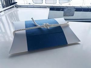Blue and gray presentation board tied with rope on a bright table