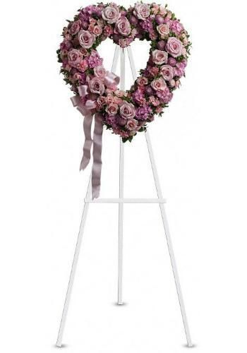 Pink flower heart wreath on a white easel stand