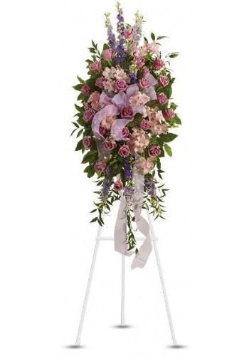 Tall pink and purple floral arrangement on a white standing easel