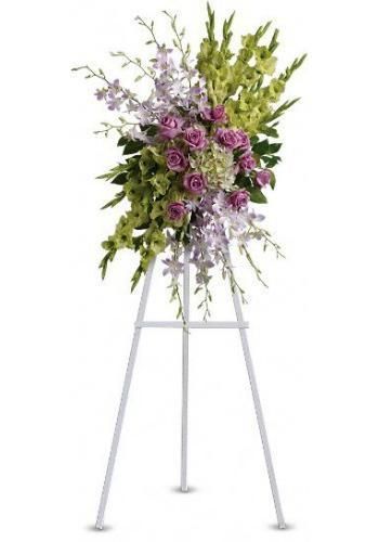 Purple and green floral arrangement on a white easel stand