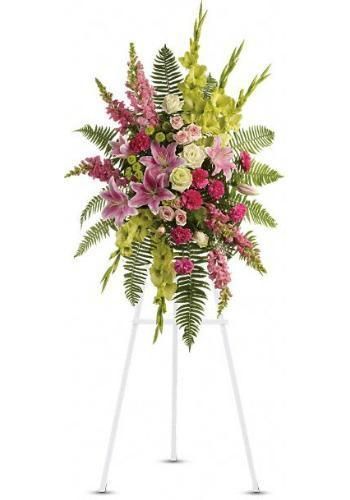 Pink and white floral arrangement with greenery on a white tripod stand