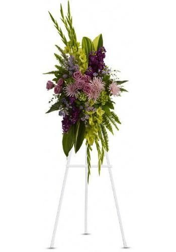 Tall floral arrangement with purple and pink flowers on a white stand