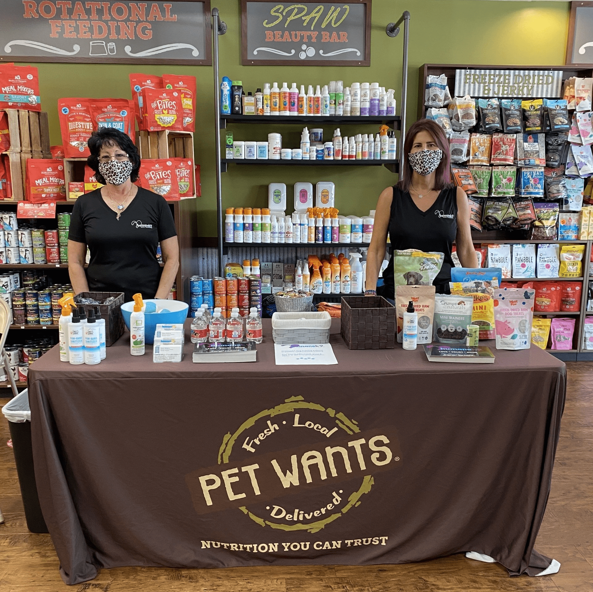 two women at a table selling dog products