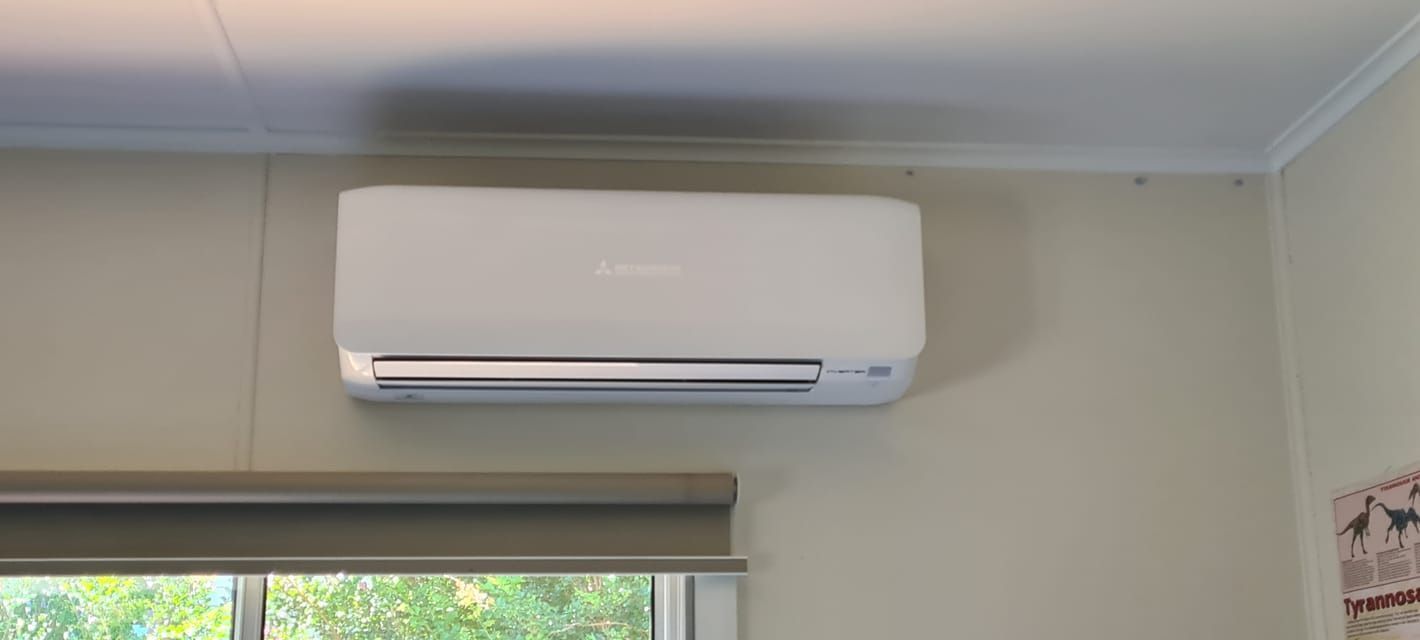 White Air Conditioner Hanging From The Ceiling In The House — Stand Fast Electrical Pty Ltd in Warwick, QLD