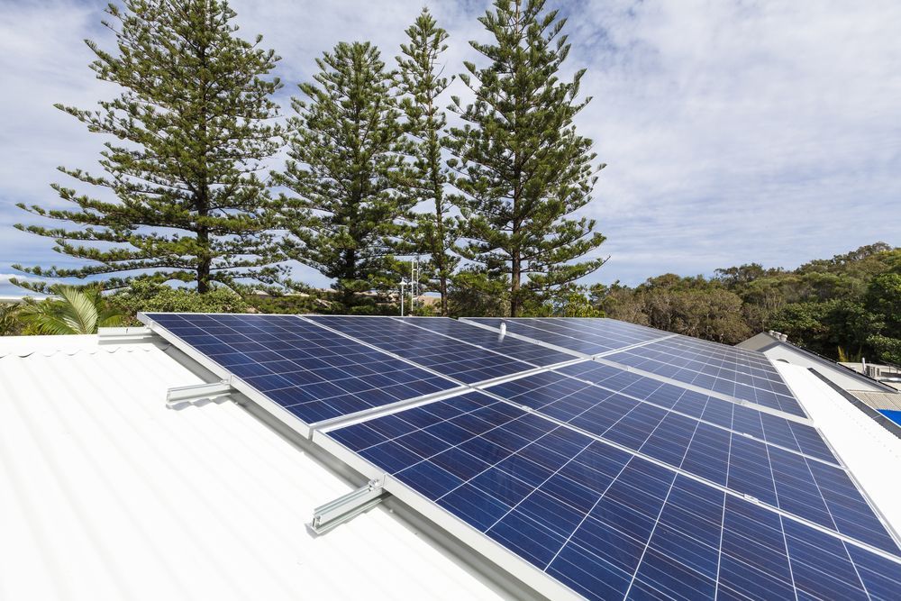 Solar Panels On A White Home Roof — Stand Fast Electrical Pty Ltd in Inglewood, QLD