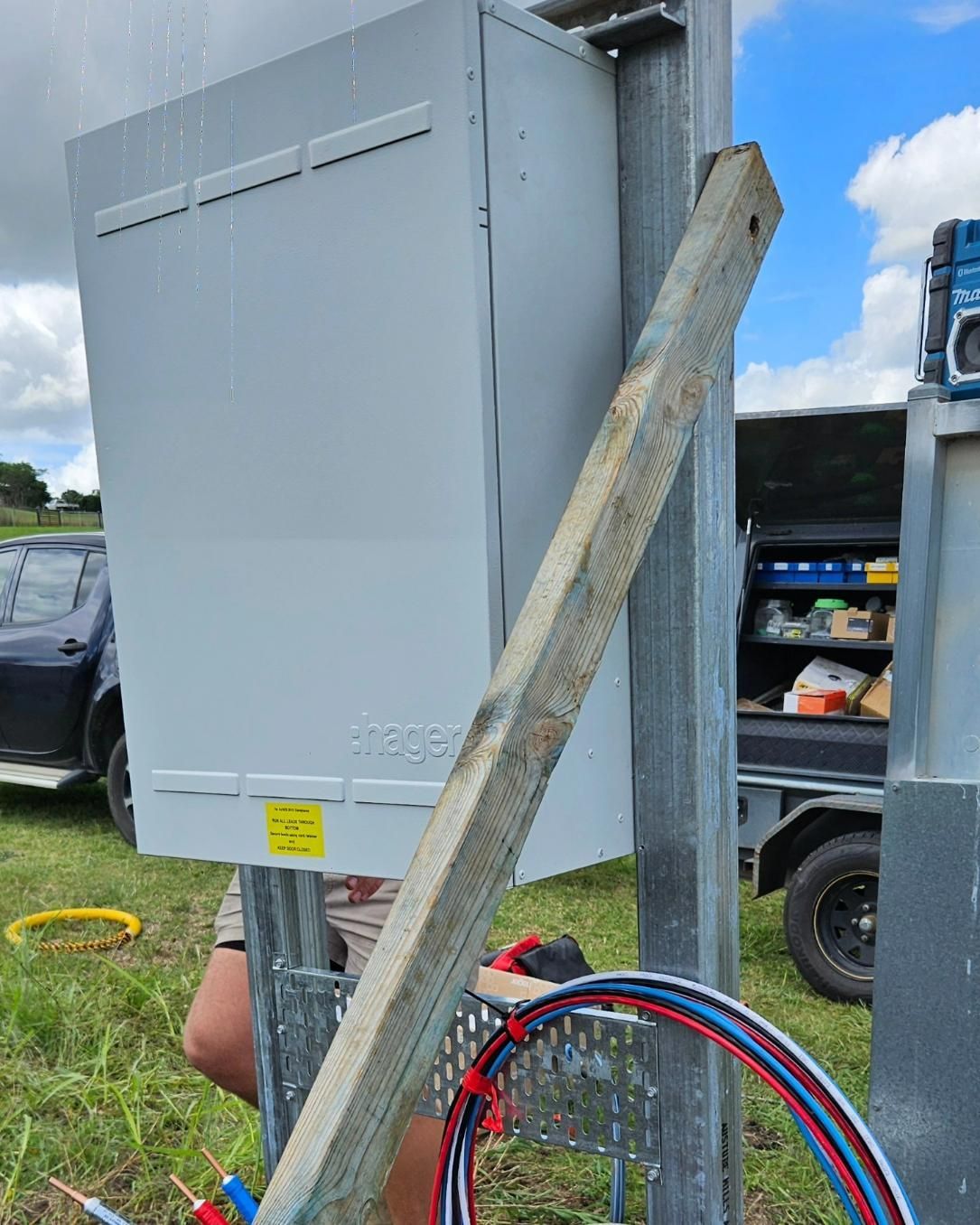Man Working On Electrical Box In The Field — Stand Fast Electrical Pty Ltd in Allora, QLD