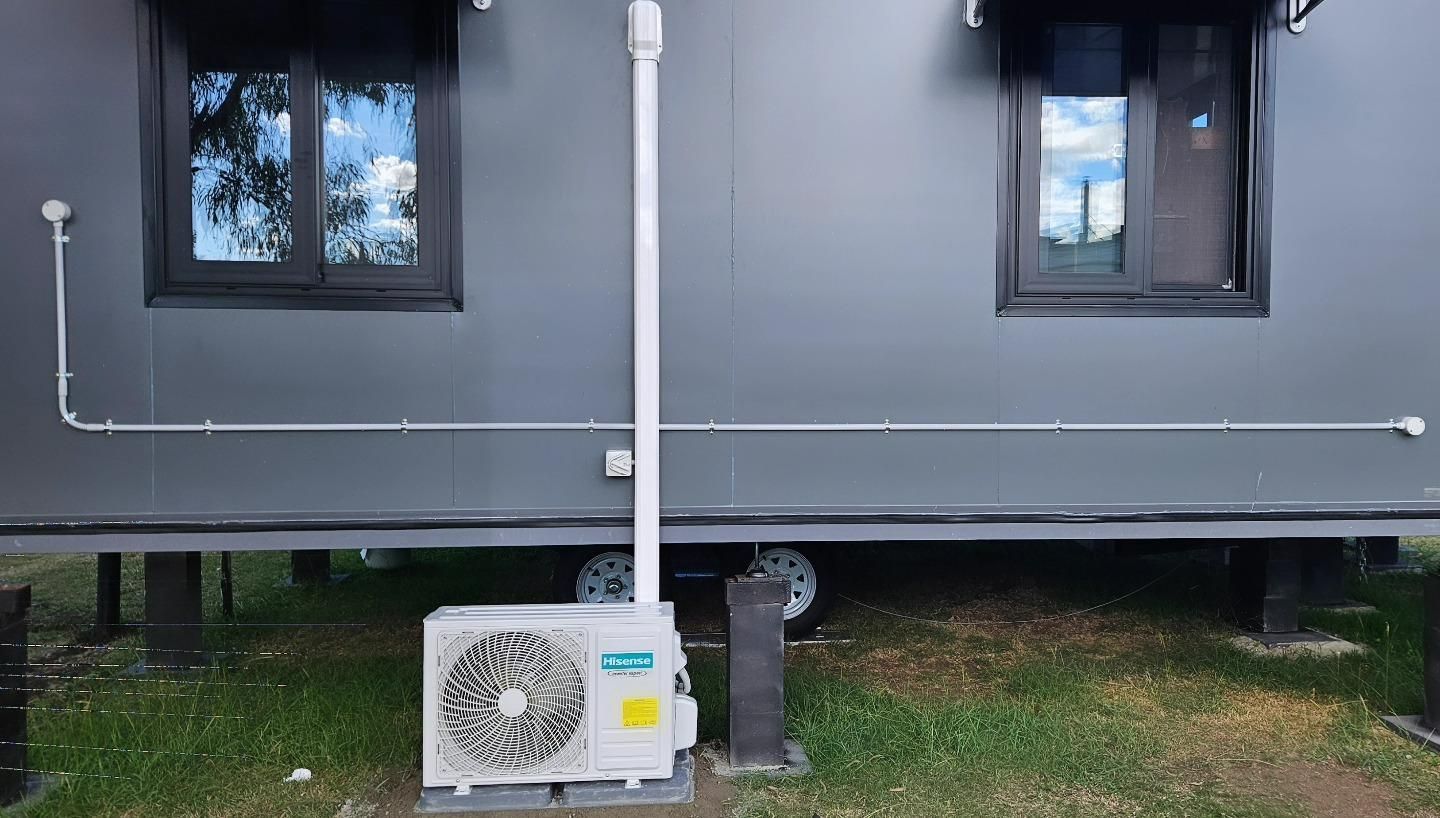 Newly Installed Conditioner On The Side Of The House — Stand Fast Electrical Pty Ltd in Warwick, QLD