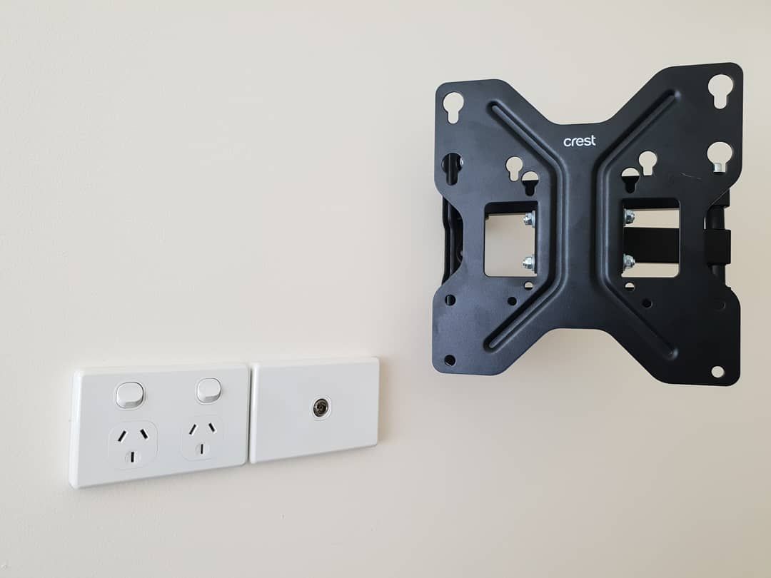 Tv Mount Is Attached To A Wall Next To Two Electrical Outlets — Stand Fast Electrical Pty Ltd in Allora, QLD