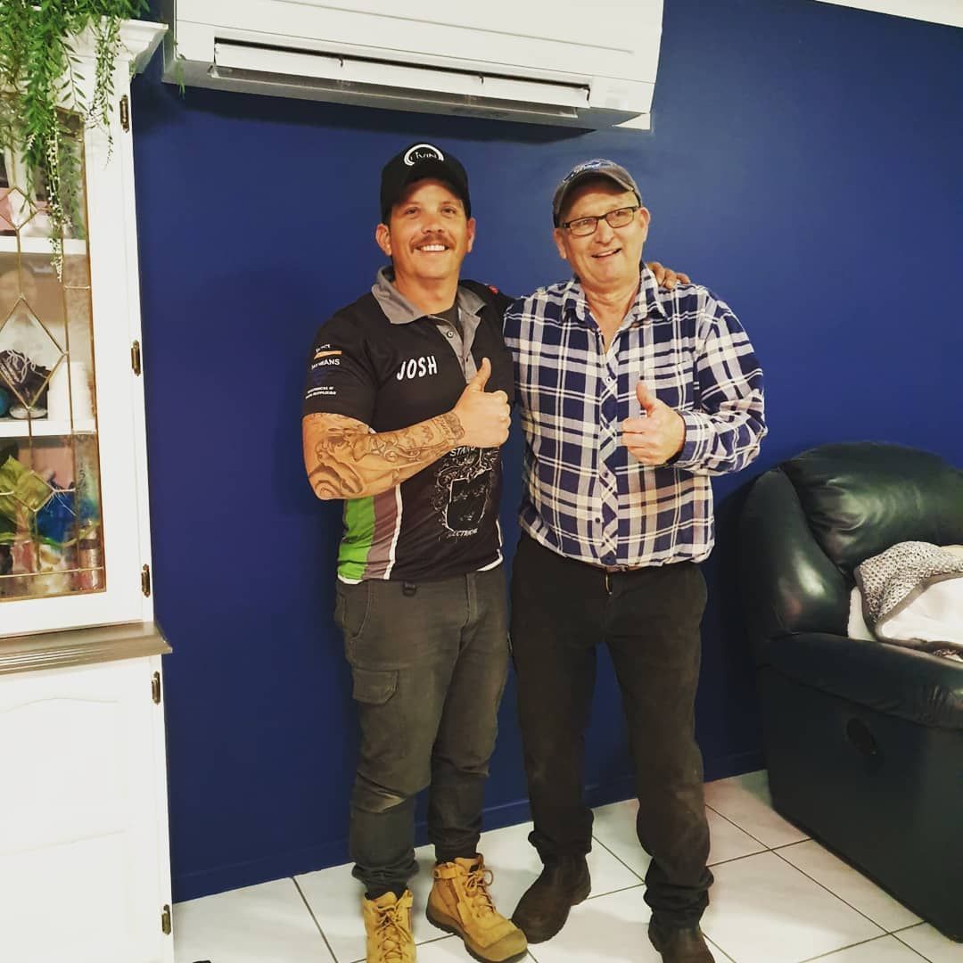 Two Men Standing Besides Each Other Under The Air Conditioner — Stand Fast Electrical Pty Ltd in Warwick, QLD